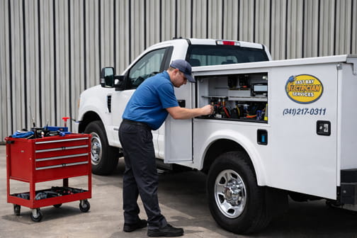 Mechanic performing utility truck maintenance