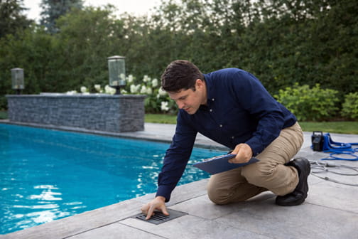 Pool inspector conducting thorough on-site pool and equipment inspection