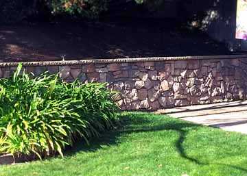 This photo was taken after the final construction of a custom-designed stone retaining wall in Walnut Creek, CA