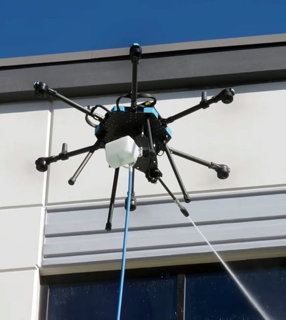 Drone operator preparing for exterior window cleaning work